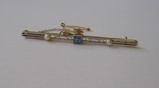 An  Art  Deco  15ct gold bar brooch set a square  cut  blue  stone supported by 2 pearls