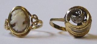 A  gold  dress  ring set a shell carved  cameo  and  a  Continental gold scroll shaped dress ring set "diamonds" 