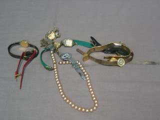 A  string  of simulated pearls and a small collection of  old  wrist watches