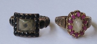 A Victorian jet and gilt metal mourning ring set a hair  sculpture, dated 1835 together with a lady's gold dress ring set pink  stones (2)