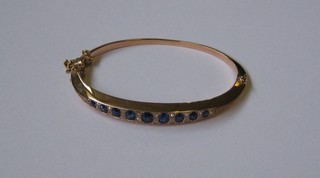 A lady's gold bracelet set 9 sapphires, supported by 18  diamonds