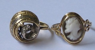 A gold dress ring set a shell carved cameo and a Continental gold scroll shaped dress ring set "diamonds" 