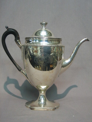 A 19th Century Georgian style silver plated coffee pot raised on a spreading foot