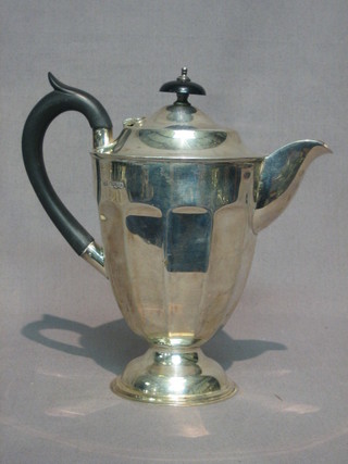 A  circular  silver  hotwater jug on a  circular  foot,  Birmingham 1938 13 ozs