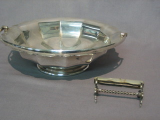 A  circular silver plated cake basket with swing handle,  a  silver plated knife rest and a silver bladed fruit knife