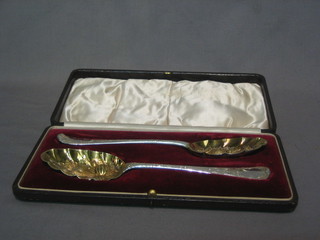 A  pair of antique bottom marked silver berry spoons  with  later embossing to bowls, 5 ozs, cased
