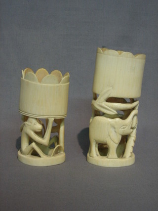 A  cylindrical  pierced section of ivory carved animals 6"  and  1 other 5"