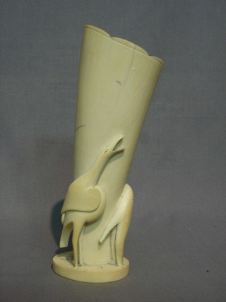 A  carved ivory section of tusk in the form of a vase  decorated  a bird and an elephant 8"