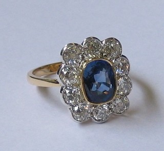 A  lady's  18ct  yellow gold dress ring set  an  oval  cut  sapphire surrounded by 10 diamonds approx 1.40/1.90ct