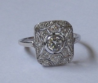A  white  gold  Art  Deco  style dress  ring  set  a  large  circular diamond   supported   by  numerous  diamonds   approx.   0.65ct