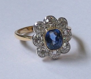 A  lady's  attractive  18ct yellow gold dress ring set  an  oval  cut Tanzanite   surrounded   by  8   diamonds   approx.   1.25/1.70ct