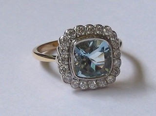 A lady's 18ct yellow gold dress ring set a square cut  aquamarine surrounded by numerous diamonds