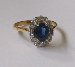 A  lady's  yellow  gold  dress ring  set  an  oval sapphire supported  by  2  baguette cut diamonds and  10  other  diamonds