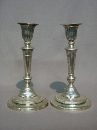 A  pair  of Victorian silver candlesticks with  detachable  sconce, semi-reeded  bodies, Sheffield 1891, 8 1/2" (1 with sconce f  and  r)