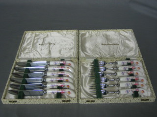 A  set  of  6  Royal  Crown Derby  cake  knives  and  forks  with stainless steel handles, cased