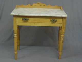 A Victorian pine wash stand with three quarter gallery and  white veined  marble  top,  the base fitted a  drawer,  raised  on  turned supports 30"