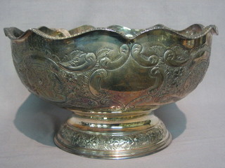 An  embossed  circular  silver plated punch  bowl  complete  with ladle 12"