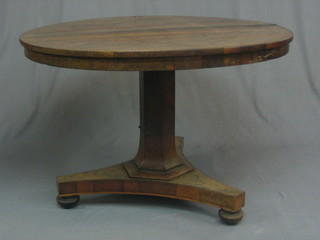 A  William IV circular rosewood snap top breakfast table,  raised on a chamfered column with triform base (some beading  missing from column and split to centre) 43"
