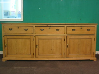 A  19th Century pine dresser base fitted 3 drawers above a  triple cupboard, raised on a platform base 94"
