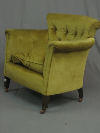 An  Edwardian mahogany framed tub back armchair  upholstered in gold buttoned material