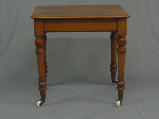 A  Victorian  bleached  mahogany  rectangular  occasional   table raised  on  turned  supported  ending in  brass  caps  and  ceramic castors 24"
