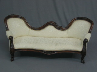 A reproduction Victorian mahogany show frame miniature double  spoon  back  settee  upholstered in white material  and  raised  on  cabriole supports 44"