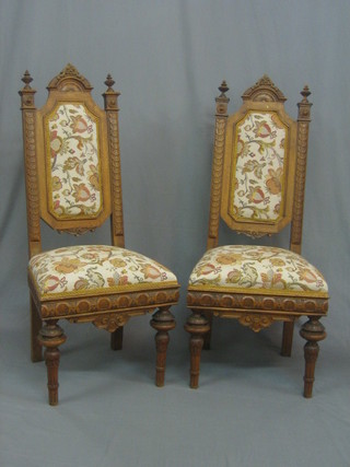 A  pair  of  Victorian  carved oak high  back  dining  chairs  with upholstered seats and backs, raised on turned and fluted  supports