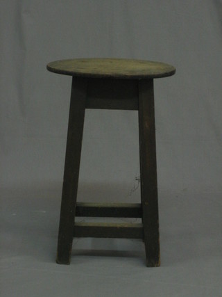 A 19th Century oval elm stool on square supports