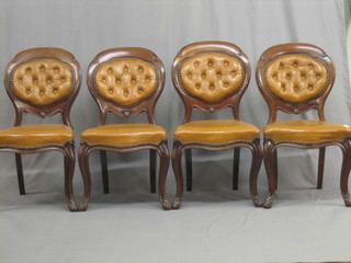 A  set  of 4 Victorian mahogany framed spoon  back  chairs  with buttoned leather backs, raised on cabriole supports