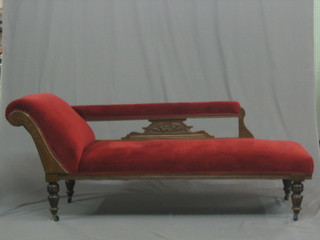 An Edwardian carved mahogany show frame chaise longue raised on turned supports