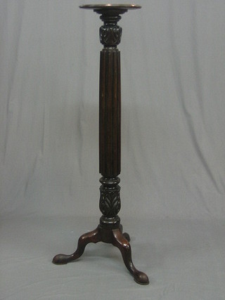 A  Victorian mahogany bed post torchere, raised on a turned  and reeded column