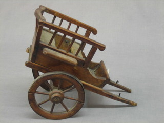A  small wooden model of a cart 10", an oval white wicker work basket 8" and a collection of various miniature copper kettles  etc