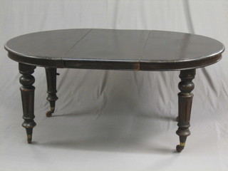 A  Victorian  stained oak oval extending  campaign  dining  table with  1  extra  leaf  raised on 4  turned  and  fluted  supports  62"  complete with iron winding handle