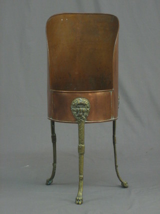 A copper and brass coal hod raised on lion supports