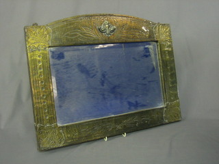 An Art Nouveau rectangular bevelled plate mirror contained in an embossed and engraved metal shaped frame 21"