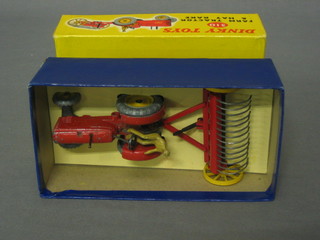 A  Dinky  Toy  310  farm tractor  and  hay  rake   complete  with figure, boxed
