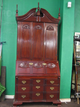 A  20th  Century Queen Anne style mahogany  bureau  bookcase, the upper section with broken pediment, the interior fitted various pigeon  holes enclosed by panelled doors, the base with fall  front  revealing  a  well fitted interior above 3 long drawers,  raised  on  bracket feet 43"