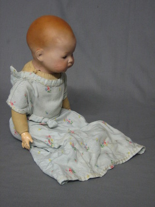 An  Armand Marseille porcelain baby doll, the head incised  AM German 341 14 with fabric body 14"