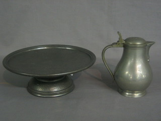 A  circular  planished  pewter  comport  9  1/2"  together  with  a modern Dutch pewter baluster lidded jug 6"