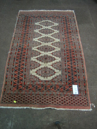 A  Bokhara  carpet with 6 stylised bells to the centre  64"  x  35" (some wear)