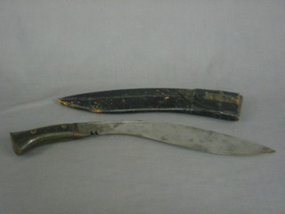 A Kukri with horn grip and leather scabbard