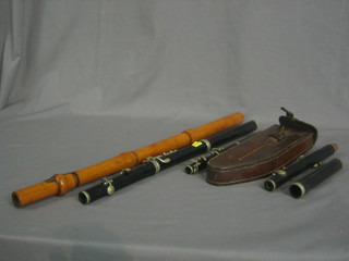 A  War Office Issue flute complete with leather carrying  case,  a wooden flute by Metzler and 1 other flute