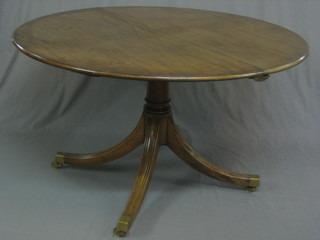 A  Georgian  oval  extending  pedestal  dining  table,  raised   on column  and tripod supports ending in brass caps and castors  48"