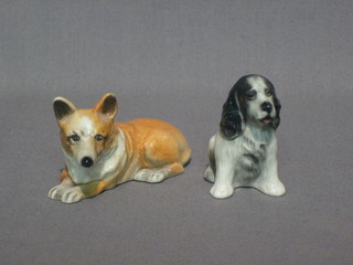 A  Brankson figure of a seated black and white Spaniel 2"  and  a figure of a reclining Corgi