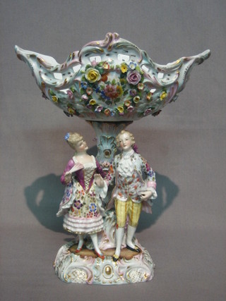 A  19th  Century  German  Continental  pierced  porcelain,   boat shaped    table   centre  piece  with  floral   encrusted   decoration supported  by  a lady and gentleman 10", the  base  with  crossed swords mark