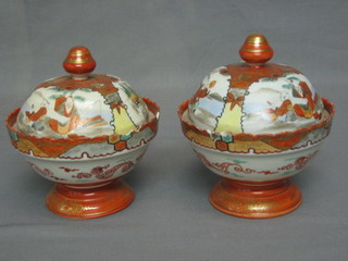 A  pair  of  circular  Kutani lidded jars  and  covers  raised  on  a circular spreading foot (both f and r) 7"