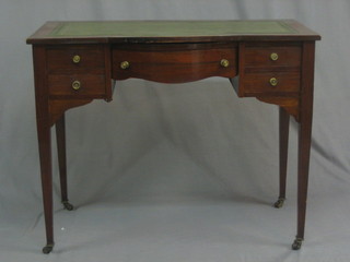 An  Edwardian  bow  front  mahogany  writing  table  with  inset tooled  green  leather writing surface, fitted 1 long  and  4  short drawers, raised on square tapering supports 35"
