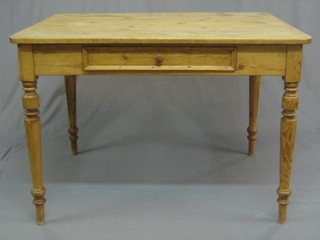 A  Victorian rectangular pine kitchen table, fitted a frieze  drawer and raised on turned supports 43"