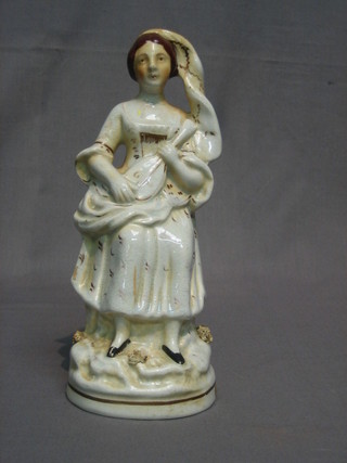 A  19th  Century  Staffordshire  figure  of  a  standing  lady  with mandolin 10"