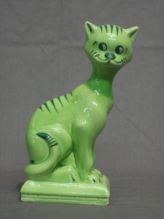 A  green glazed figure of a seated cat, the base marked  Kilkenny Cat series one, a Walter Smithwick reproduction 8"